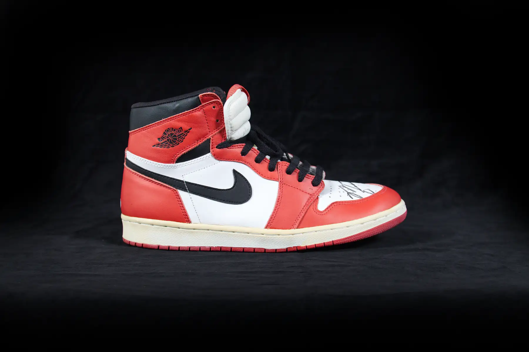 Air Jordan 1 sneaker photographed on black
