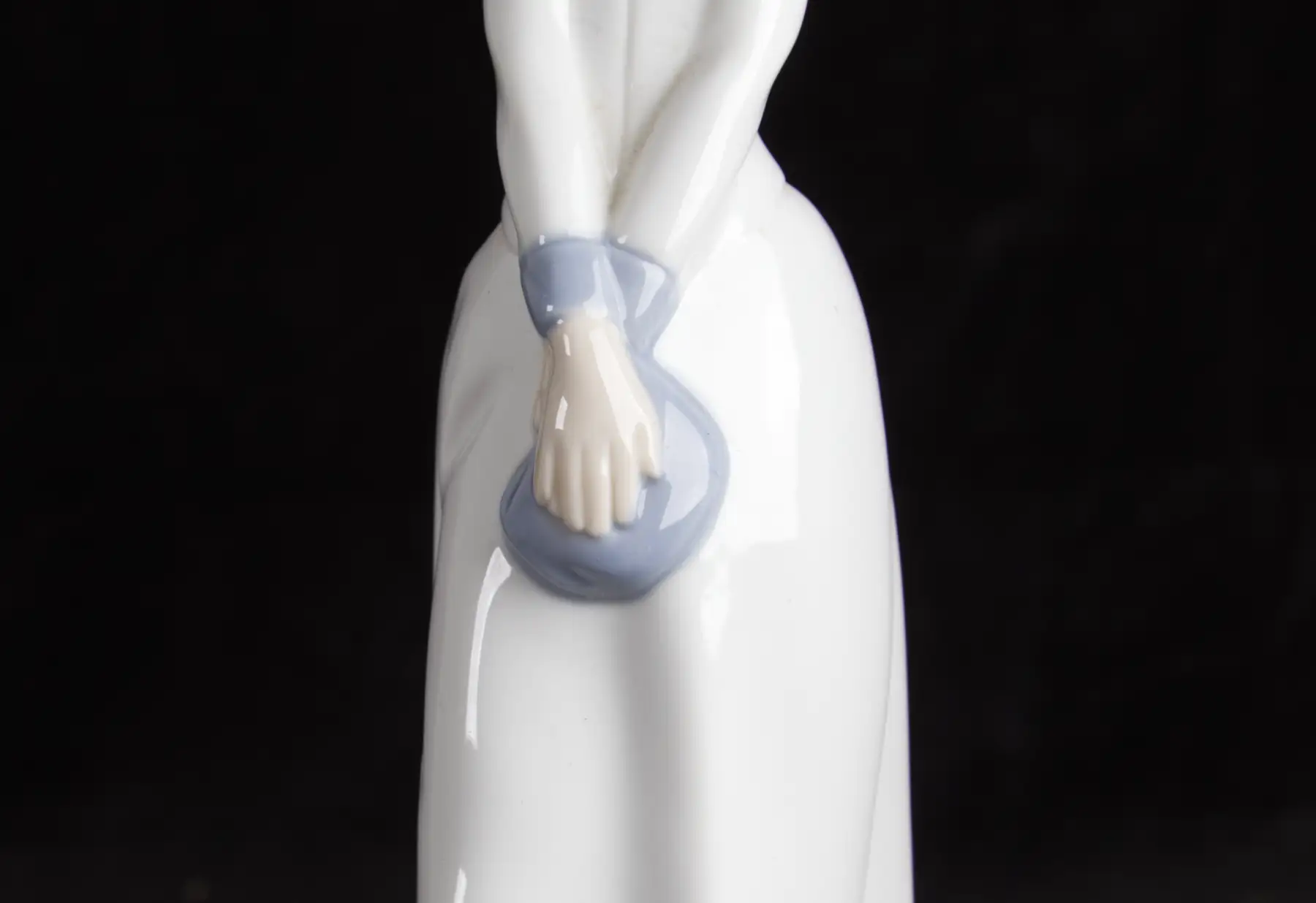 Glazed porcelain figurine on black